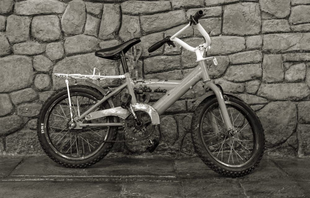 Two bicycles standing side by side outdoors