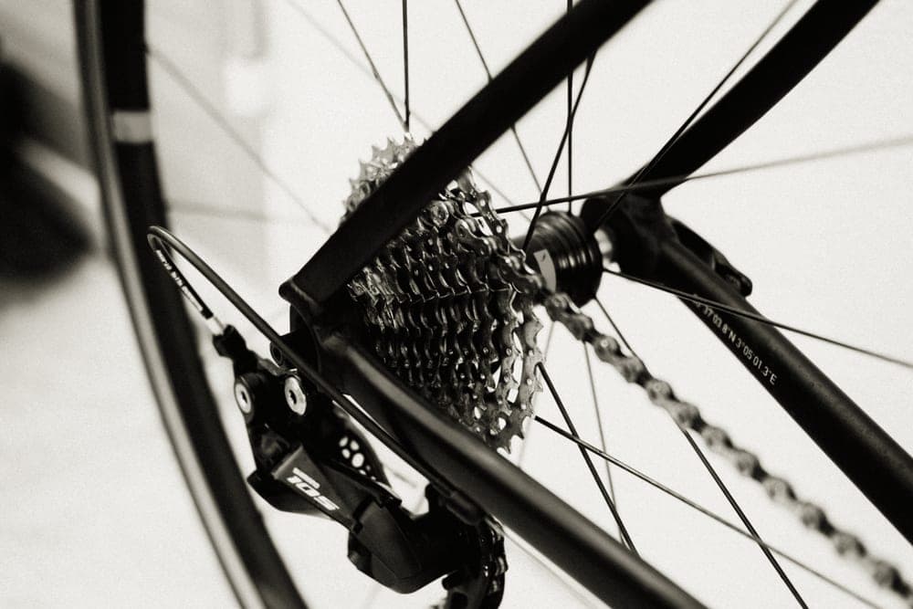Close-up of a bicycle chain running over the rear cassette sprockets