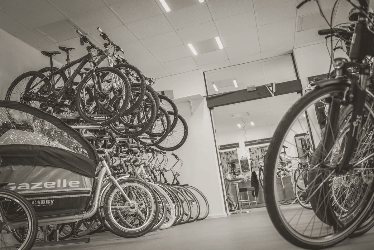 A bicycle stored indoors against a hallway wall